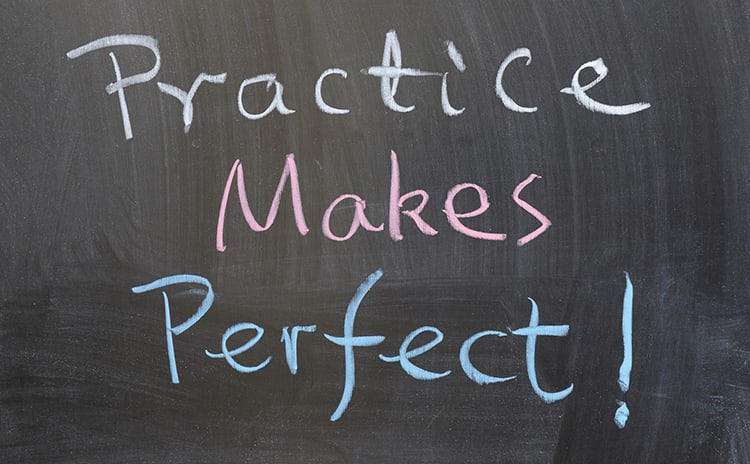 A chalkboard saying Practice Makes Perfect