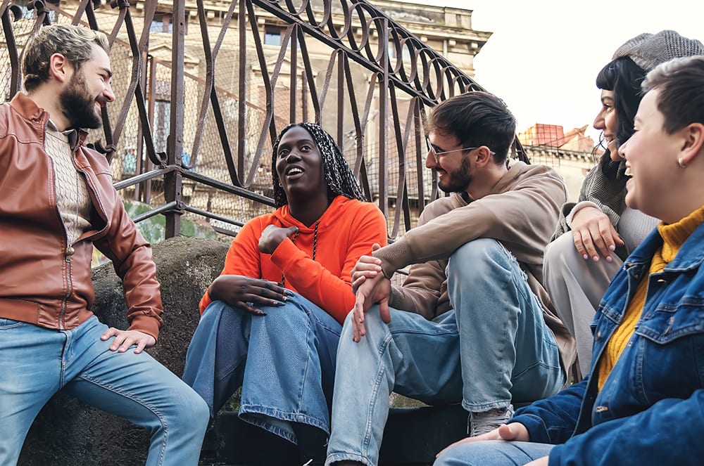 Group of people talking outside on stairs