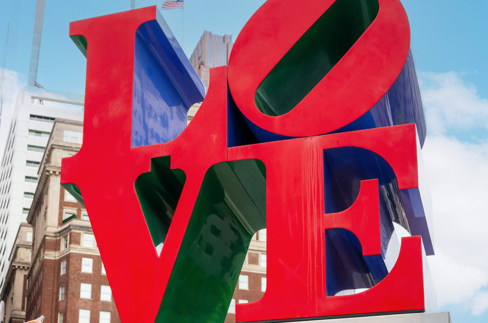 People taking photos and posing in front of the LOVE sign in Philadelphia