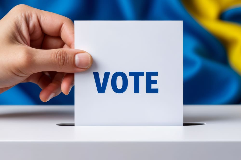 voting box with hand putting in a vote