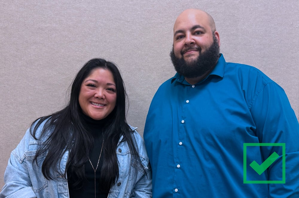 Uncluttered background photo of 2 people with simple background