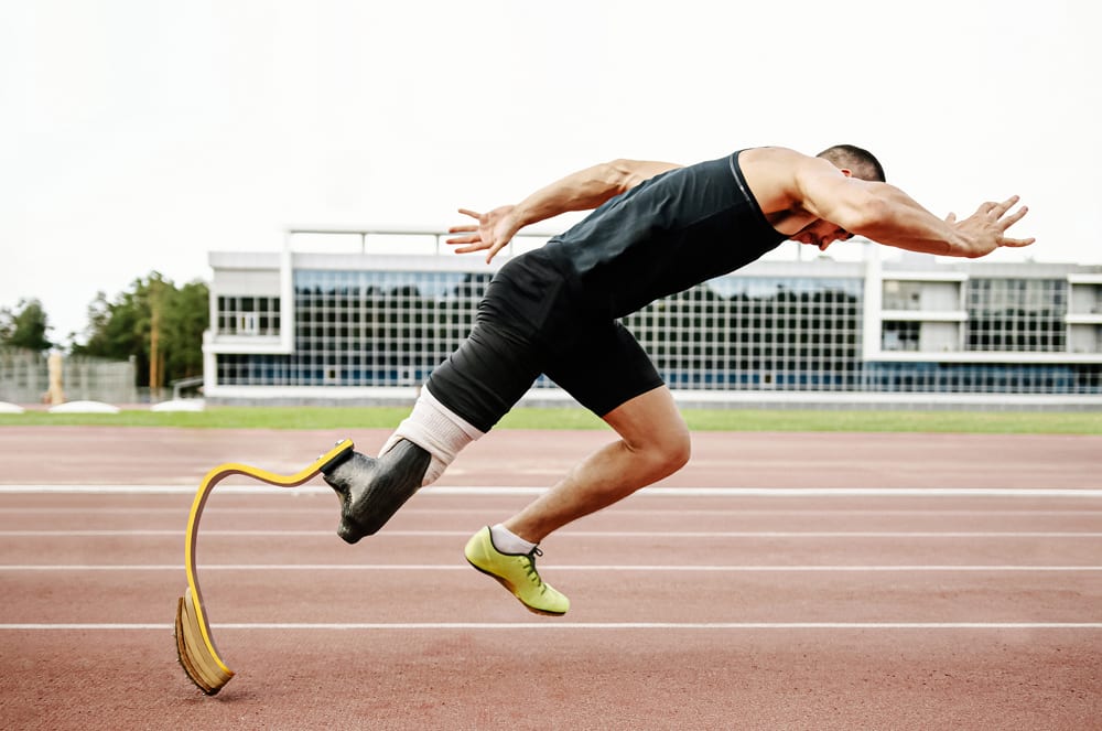 A muscular athlete in athletic gear is sprinting on a running track, with a modern building visible in the background.