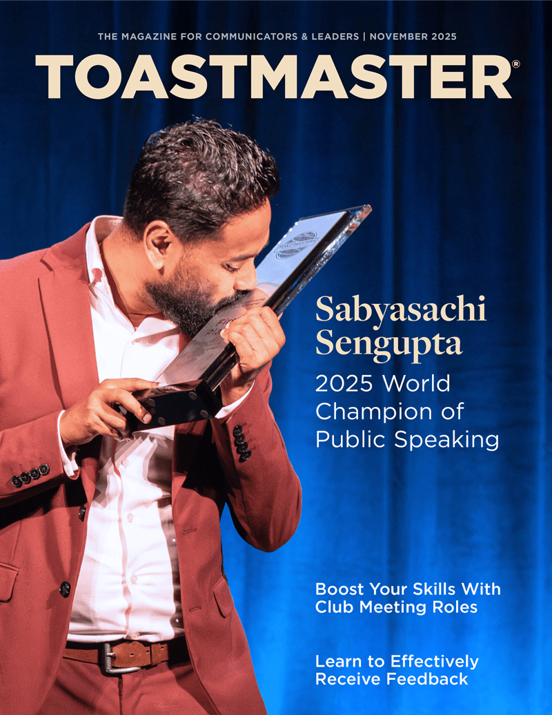 The cover of the Toastmaster magazine features a man in a red jacket speaking into a microphone, with the title "Sabyasachi Sengupta 2025 World Champion of Public Speaking" prominently displayed.