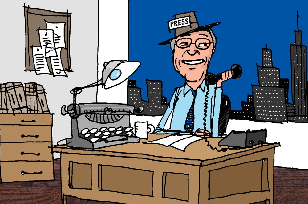 A smiling journalist wearing glasses sits at a desk in an office, surrounded by a cityscape in the background.