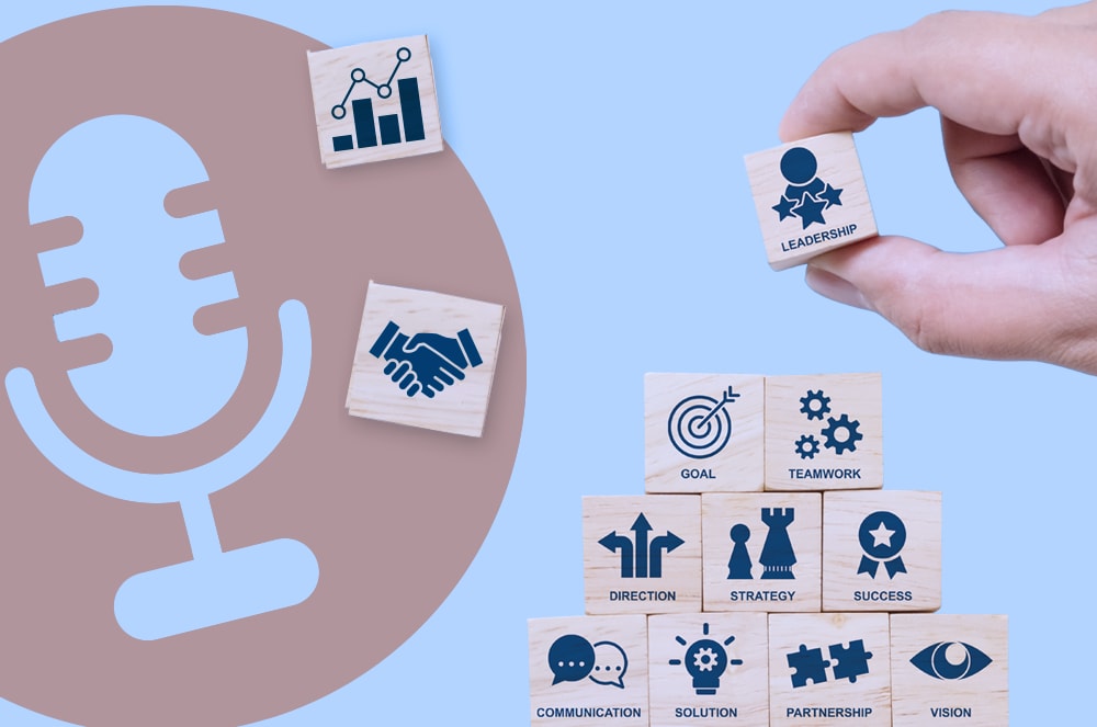 A hand stacking wooden blocks with blue icons on them