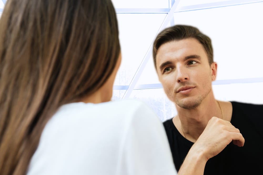 The image shows a man and a woman engaged in conversation, with the man appearing to be listening intently to the woman.