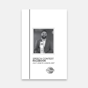 A black and white cover of a speech contest rulebook features a framed photo of a smiling man holding an award in the foreground, with a simple white background and a gray vertical line on the left.
