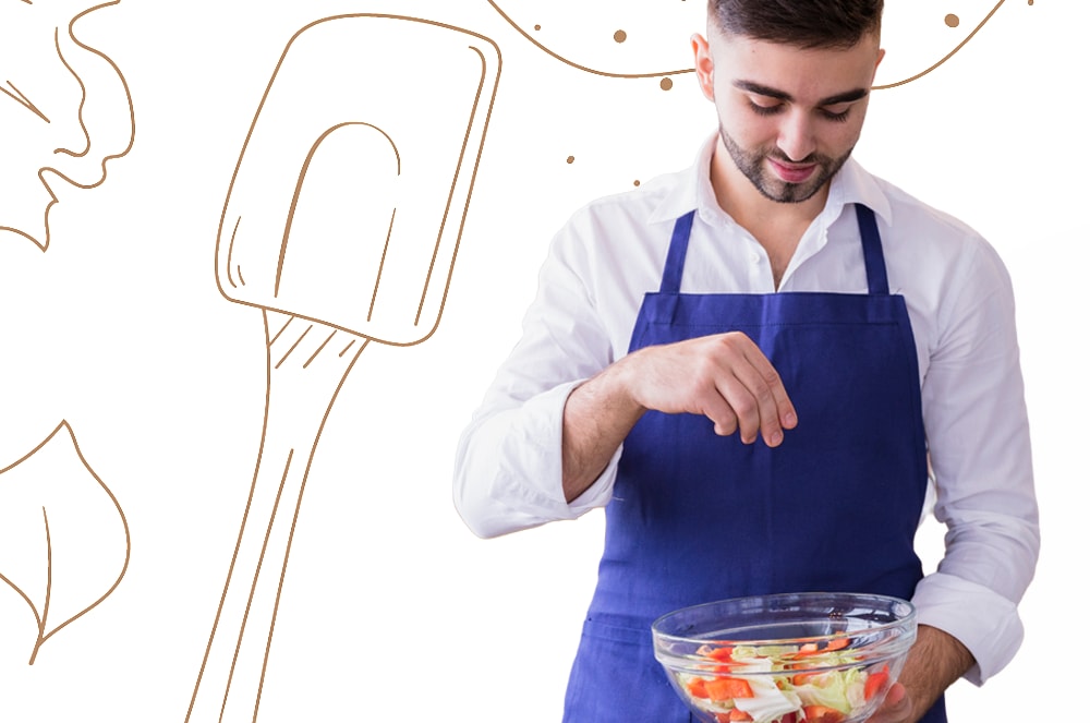 A man in a blue apron sprinkles seasoning into a bowl of chopped vegetables in the foreground, with a large spatula illustration and decorative dots in the background.