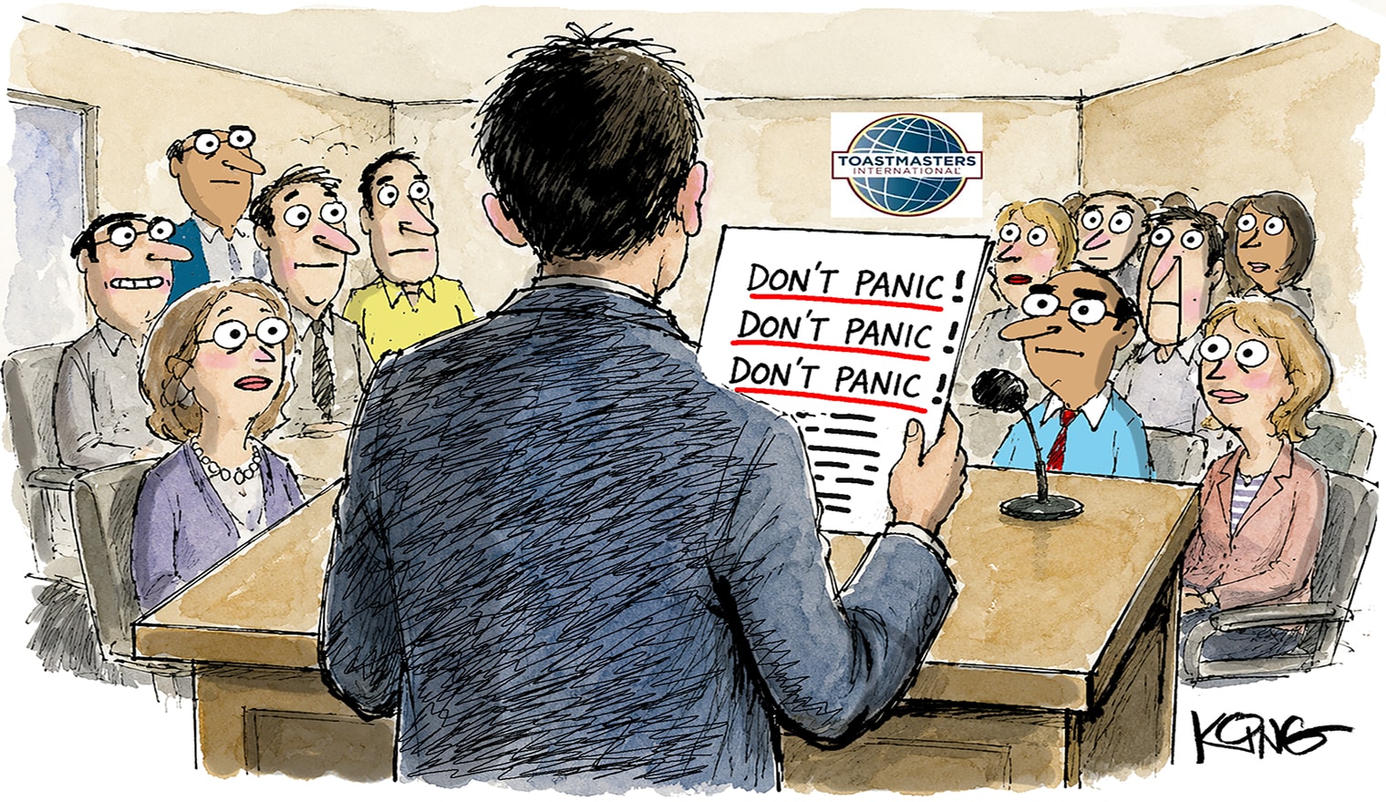 A man in a suit stands at a podium in the foreground holding a sign that says "DON'T PANIC!" while facing a crowd of concerned-looking people in the background.