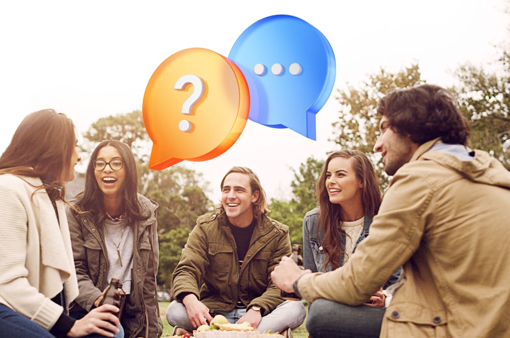 A group of people sitting outside talking and laughing