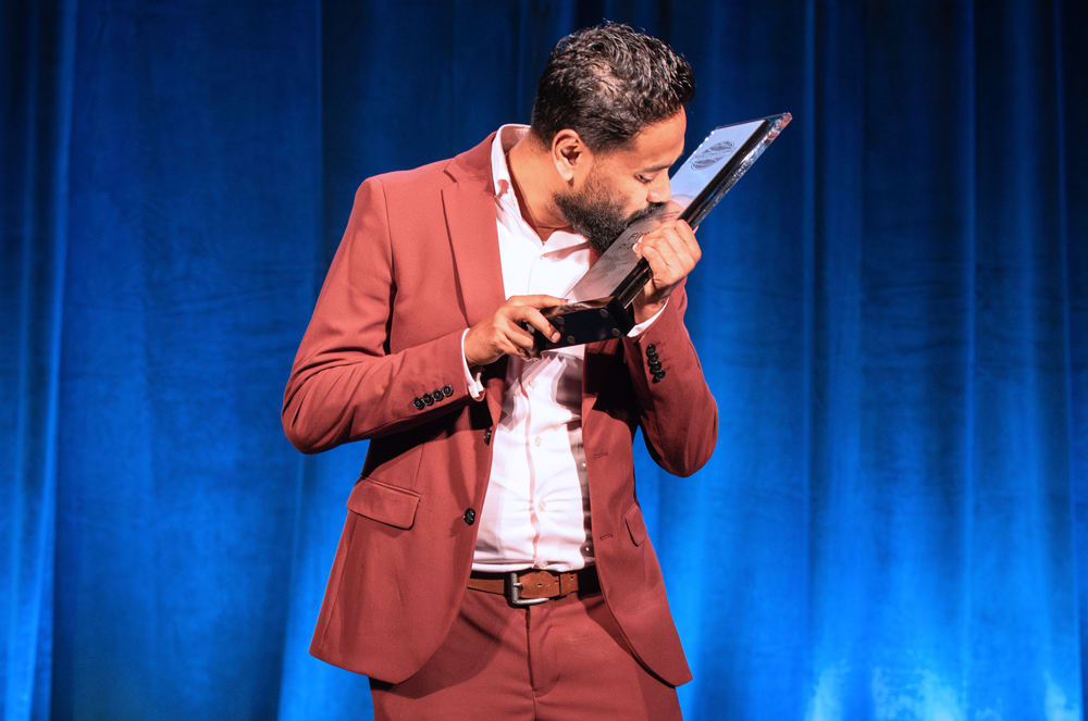 World Champion of Public Speaking Sabyasachi Sengupta kisses his trophy.