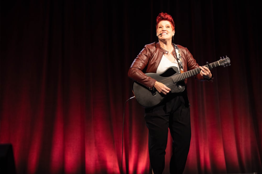 Anne Bonney sings during her keynote presentation.
