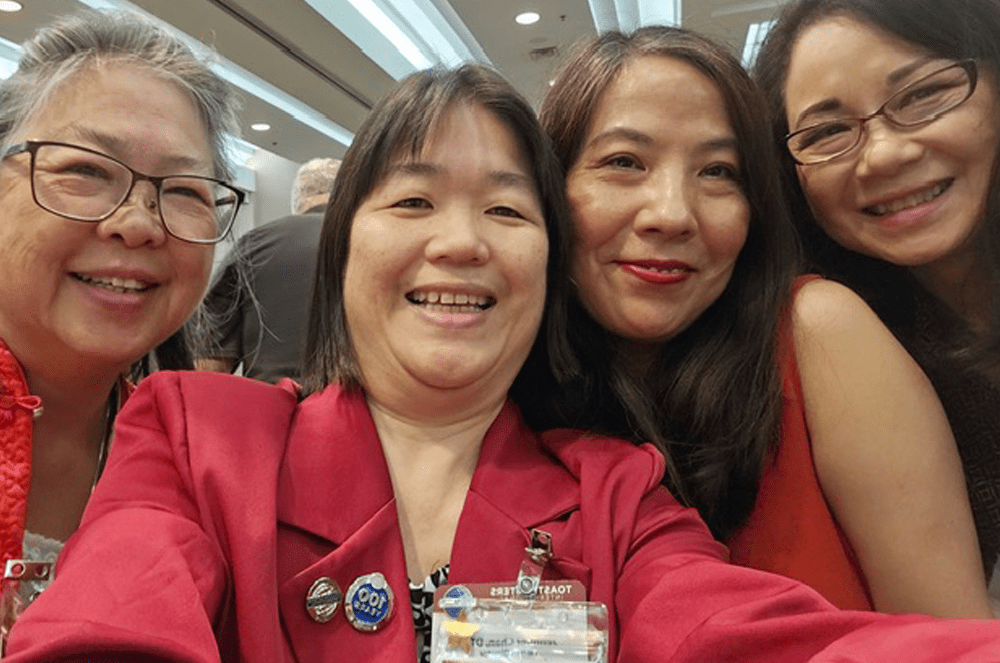Four smiling women taking a selfie together