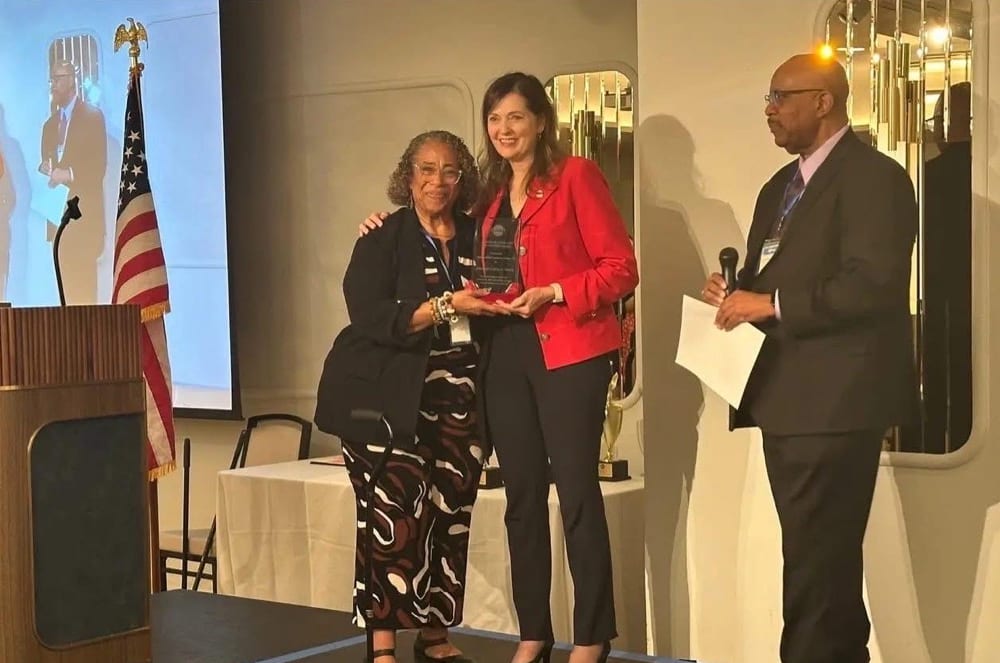 Rochat at the District 33 Annual Conference in Fresno, California, standing with Communication and Leadership Award recipient Cynthia S. Sterling and then-District Director Darnell Evans (far right).   Photo credit: Varadham Media